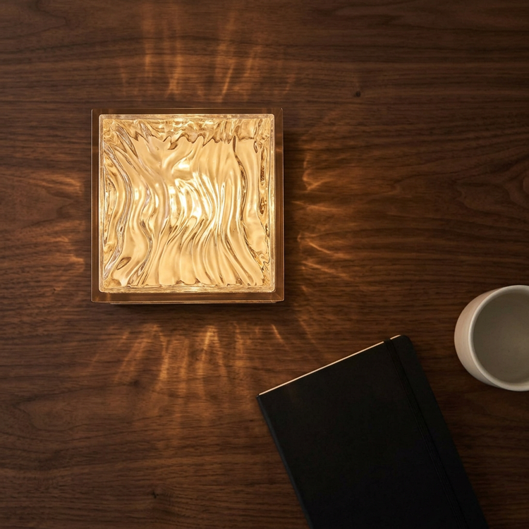 Overhead view of Aura glowing on a walnut tabletop