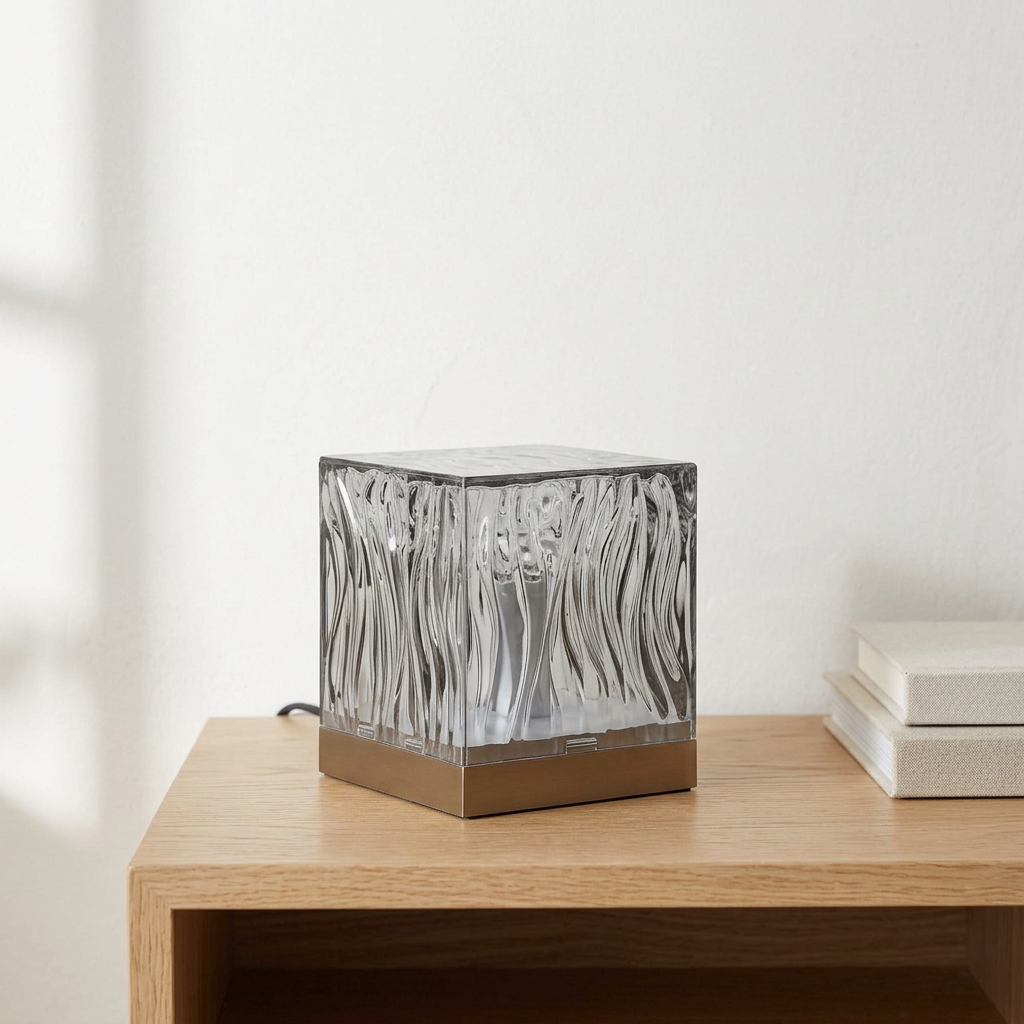 Aura switched off on a pale oak shelf in daylight
